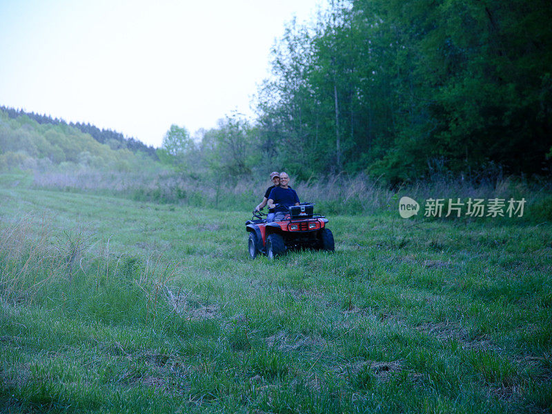 Man and Woman Couple Driving Four Wheeler All Terrain Off Road Vehicle in Motion
